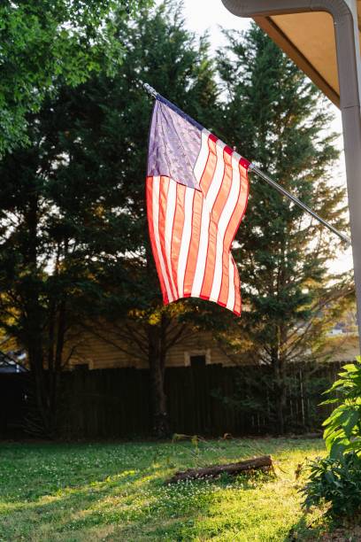 istock US flag on a pole waving in the wind 1441584473