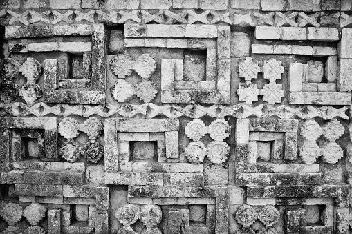 A closeup grayscale shot of the Mayan art sculptures in Yucatan Peninsula, Southeastern Mexico