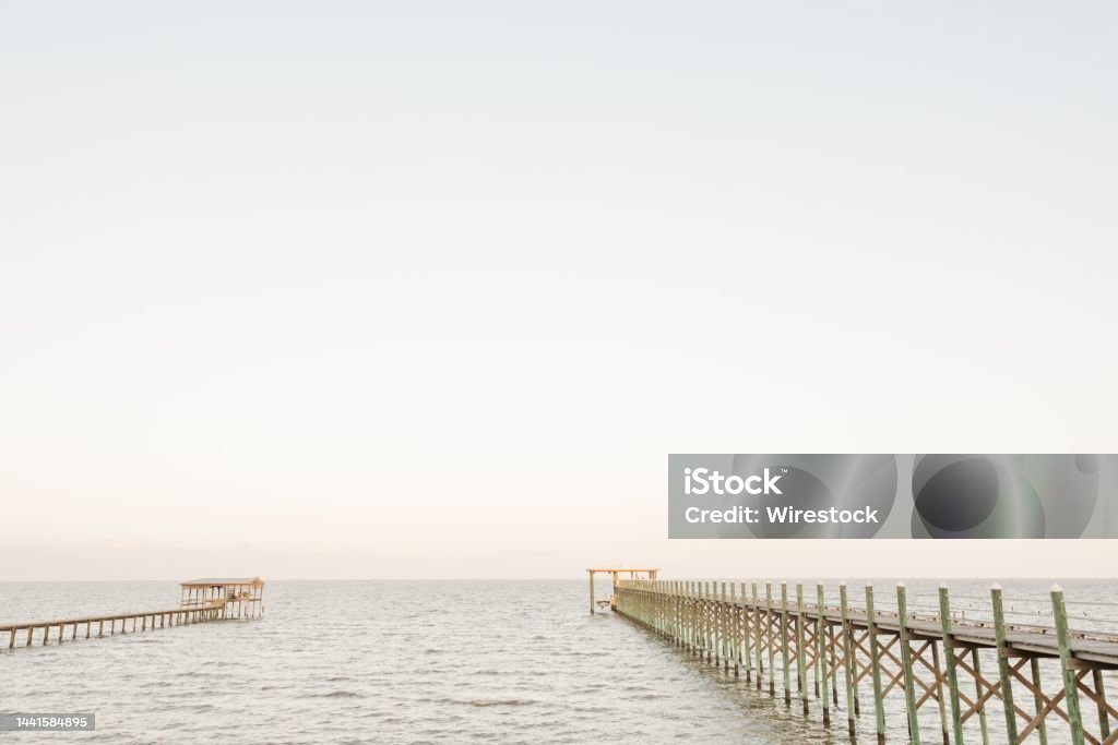 Scenic view of wooden piers on the seascape on a sunny day in Fairhope, Alabama A scenic view of wooden piers on the seascape on a sunny day in Fairhope, Alabama Alabama - US State Stock Photo