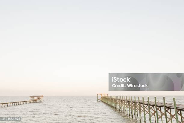 Scenic View Of Wooden Piers On The Seascape On A Sunny Day In Fairhope Alabama Stock Photo - Download Image Now