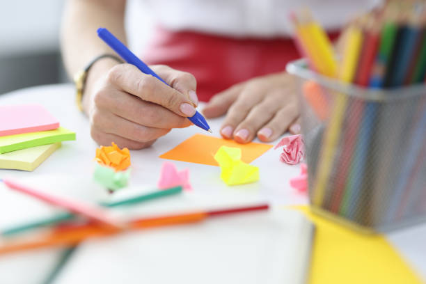 istock Woman makes business notes in colored stickers 1441585293
