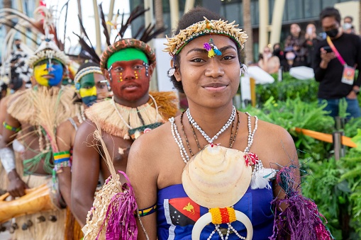 dubai, United Arab Emirates – February 28, 2022: Papua New Guinea Island first nation dancers at Expo2020 dancing in traditional clothes with feathers and bright colours face painted ocra