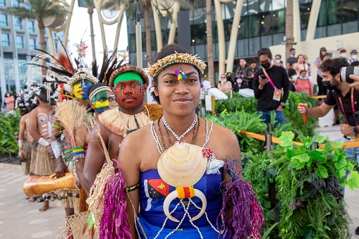 dubai, United Arab Emirates – February 28, 2022: Papua New Guinea Island first nation dancers at Expo2020 dancing in traditional clothes with feathers and bright colours face painted ocra