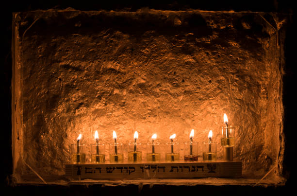 istock A Hanukkah menorah reflecting a glowing light off a stone wall 1441586021