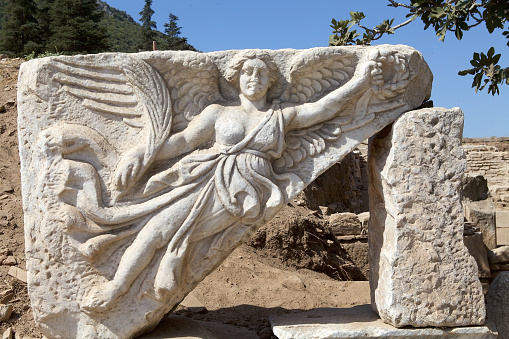 The stone carving of the goddess Nike at Ephesus archaeological site, Turkey. Ephesus was inscribed on the world heritage list in 2015. It is on the coast of Ionia, in Izmir Province was built in the 10th century BC on the site of the former Arzawan capital by Attic and Ionian Greek colonists