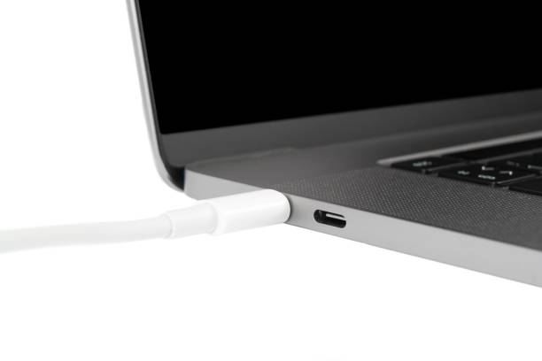 istock Modern laptop and charging cable isolated on white background. Laptop charging 1441587519