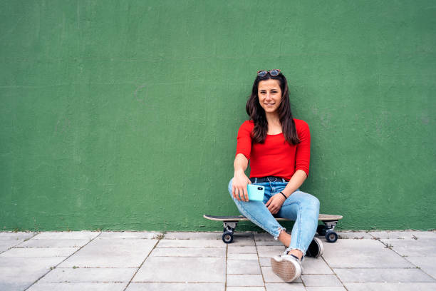 istock Skater Girl Using Phone 1441590371