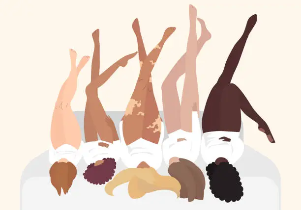 Vector illustration of Interracial beautiful women lie on the bed with their legs up