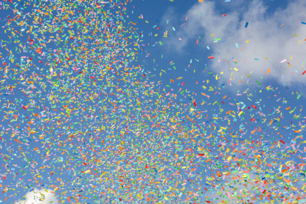 istock Colorful confetti on the air with blue sky background 1441596600