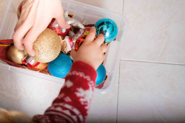 istock Mother and daughter decorating the Christmas tree 1441597558