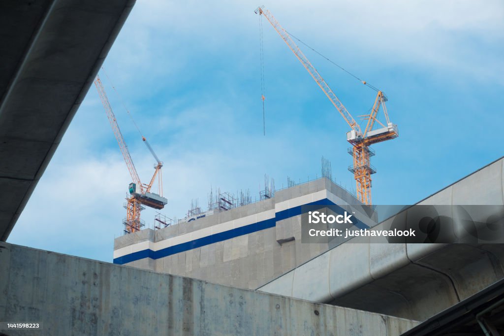 Detail of new BTS skytrain line on Phahonyothin Rd and construction cranes in Bangkok Architecture Stock Photo