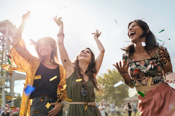 Three friends dancing at the music festival in sunny day stock photo