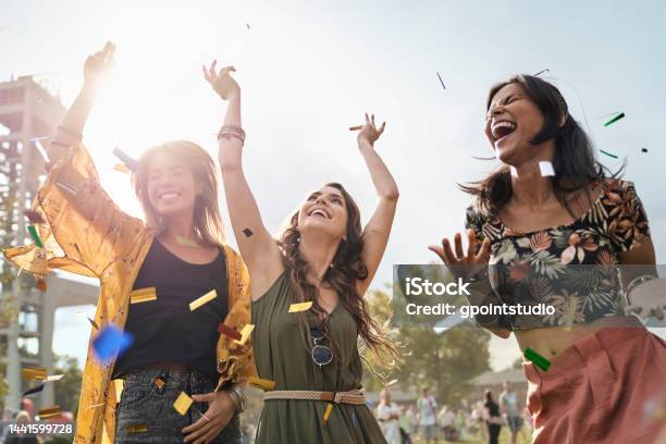Three Friends Dancing At The Music Festival In Sunny Day Stock Photo - Download Image Now