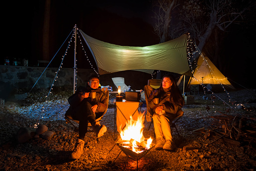 The couple sat by the campfire