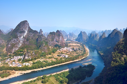 Asia,China,Guilin,Yangshuo,Xingping,Xianggong hill.\nYangshuo is a world famous tourist resort.\nYangshuo is a county of guilin prefecture.\nGuilin karst has been included in the world heritage list.\nHere the Li River snakes through a fairy-tale landscape of conical limestone peaks,its smooth waters exquisitely mirroring the magical.\nStand at the top of the hill to see the Lijiang River,\nLijiang River and its tributaries,the shuttle in the \nShiShanfeng forest,mountains and water and hold,very beautiful.\nBeautiful Lijiang River,is the world's largest and most beautiful karst landscape scenic resort.\nIt's the most beautiful landscape waterway has about 15 km.\nLarge numbers of tourists visit the Li river by yachts every year.