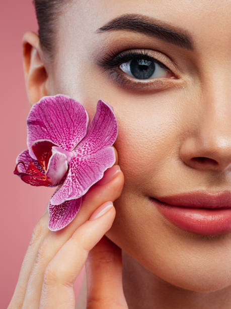istock Beautiful woman holding flower 1441606479