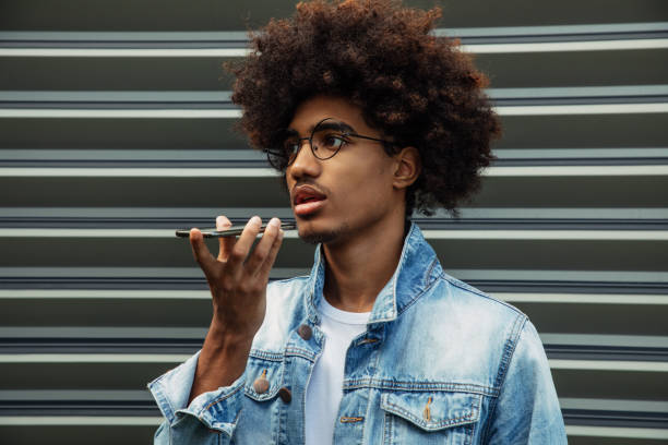 istock African american man with african hairstyle using phone 1441606871