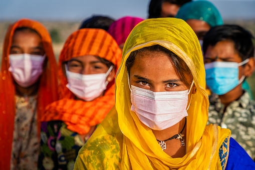 Group of Indian children wearing face masks - desert village, Thar Desert, Rajasthan, India.