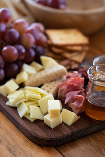 Cheese Board , ceese platter.,Assorted cheese pieces, vegetables, honey, fruits, cookies
