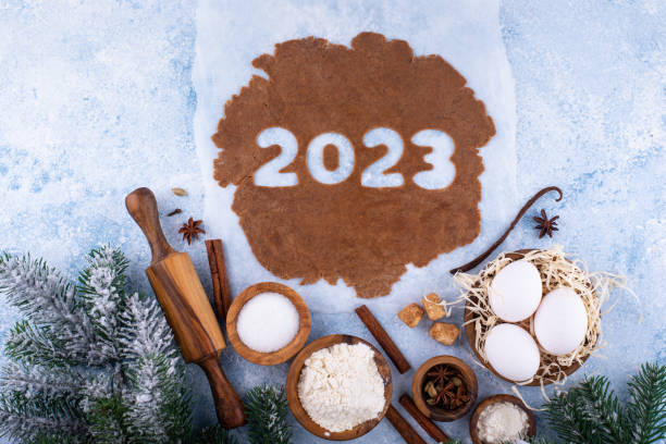 Gingerbread dough for cookies in shape of 2023 stock photo