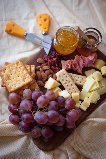 Cheese Board , ceese platter.,Assorted cheese pieces, vegetables, honey, fruits, cookies