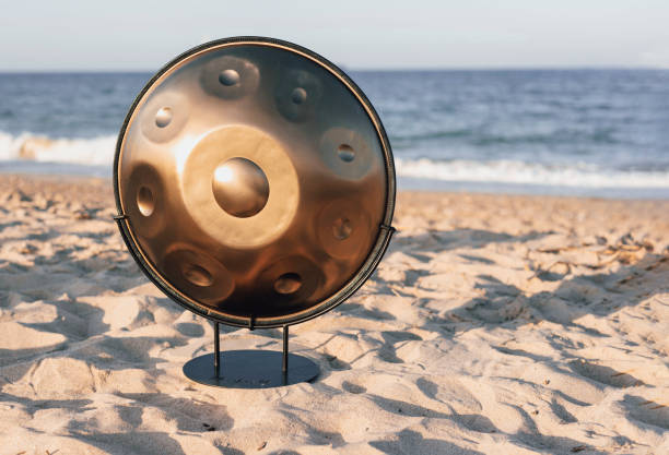 the handpan instrument on the beach the handpan instrument on the beach steel drum stock pictures, royalty-free photos & images