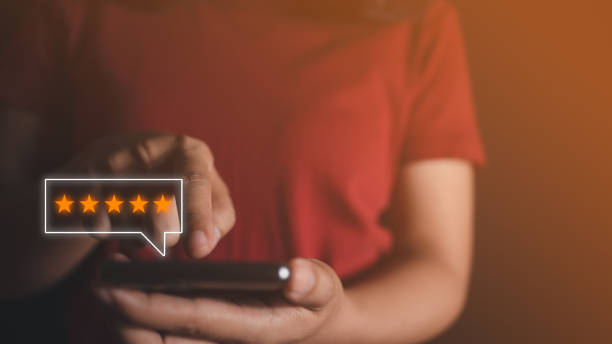 istock Customer touch smart phone on screen to review satisfaction feedback survey concept, User give rating to service experience on online application, Customer can evaluate quality of service leading to reputation. 1441611275