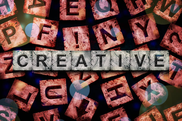 Creative, word on an alphabet on stone blocks, on a red background, with different letters.