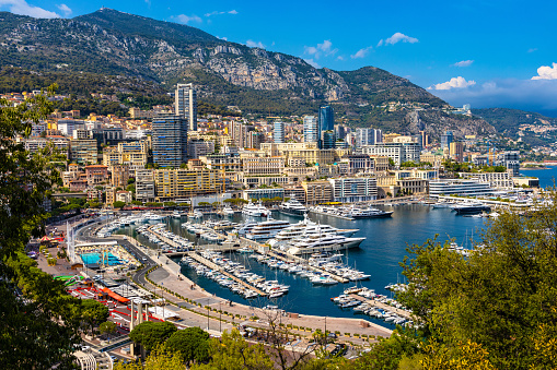 Monaco, France - August 2, 2022: Panoramic view of Monaco metropolitan area with Hercules Port, La Condamine, Monte Carlo and Fontvieille quarters at Mediterranean Sea coast