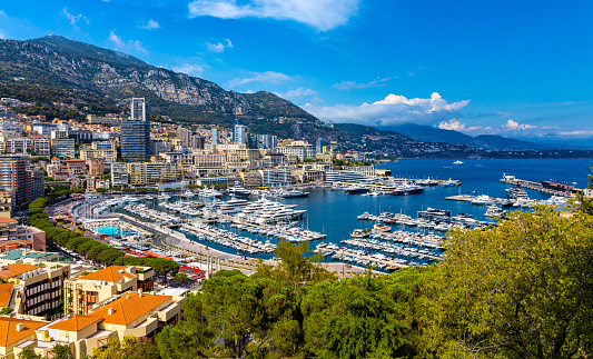 Monaco, France - August 2, 2022: Panoramic view of Monaco metropolitan area with Hercules Port, La Condamine, Monte Carlo and Fontvieille quarters at Mediterranean Sea coast