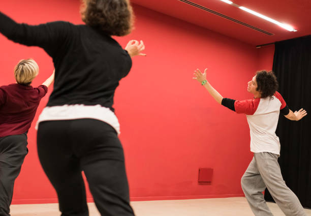 istock Physical theater teacher indicates movement to two students who imitate him 1441617114