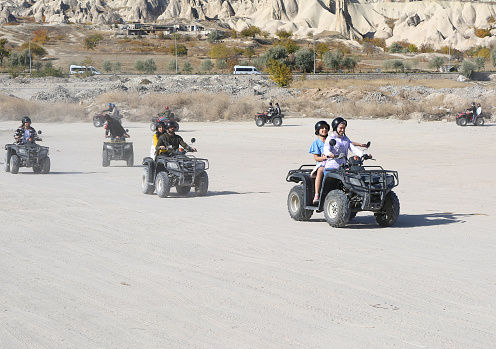 Goreme, Nevsehir, Turkey-November 05,2022 :Unidentified Young People enjoying ATV Ride in Cappadocia