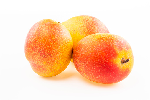 Ripe whole peach fruit with green leaf isolated on white background with clipping path. Full depth of field.
