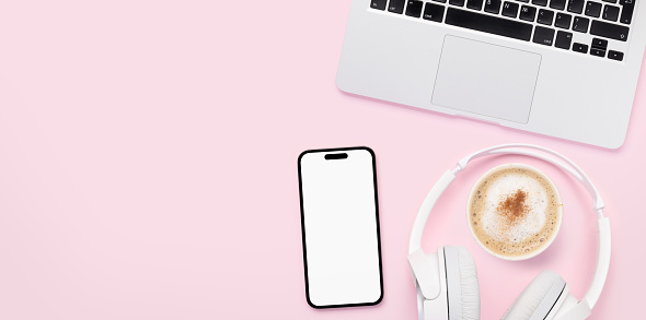 Smartphone, headphones and laptop with blank screen on pink background. Flat lay with copy space