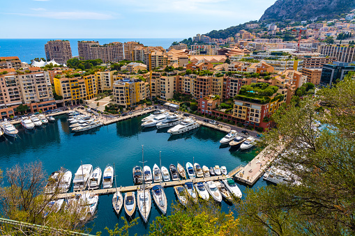 Monaco, France - August 2, 2022: Panoramic view of Monaco metropolitan area with Port Fontvielle yacht marina with surrounding residences at Mediterranean Sea coast