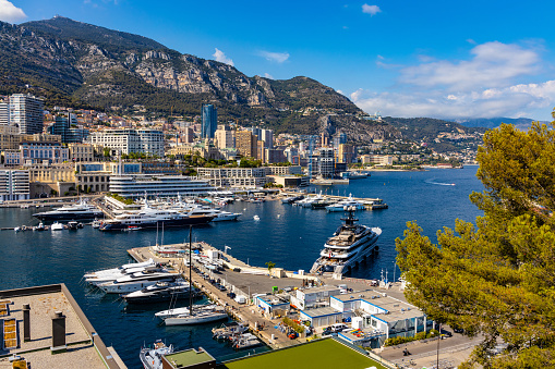 Monaco, France - August 2, 2022: Panoramic view of Monaco metropolitan area with Hercules Port, La Condamine, Monte Carlo and Fontvieille quarters at Mediterranean Sea coast