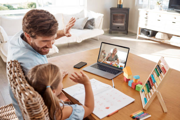 istock E learning, video call and teacher with child and dad study education or homework at home. Virtual, online and distance learning with father and girl student remote, class or school 1441621612