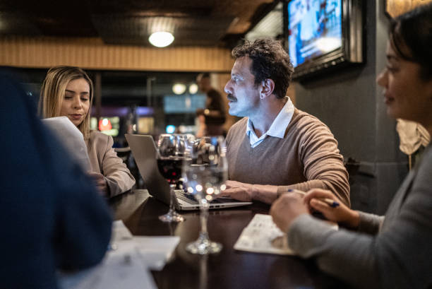 istock Coworkers doing a meeting at a bar 1441623161