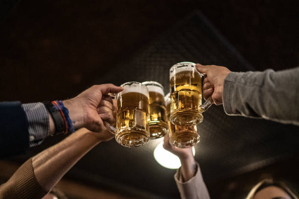 istock Friends toasting a beer at a bar 1441623335