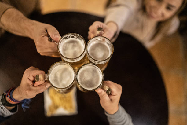 istock Friends toasting a beer at a bar 1441623352