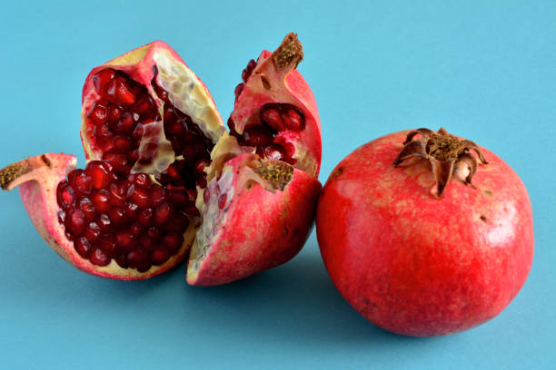 istock red pomegranate isolated with halves of fruit, close-up 1441624924
