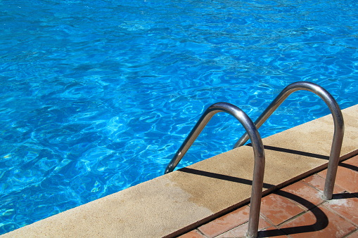 a metal ladder in the pool
