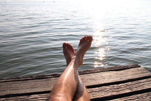 feet on in the sun at the lake