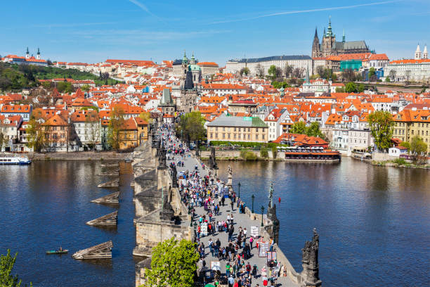 Charles Bridge over Vltava river crowded with tourists in Prague, Czech republic Prague, Czech Republic - April 26, 2012: Charles Bridge over Vltava river crowded with tourists in Prague, Czech republic hradcany castle stock pictures, royalty-free photos & images