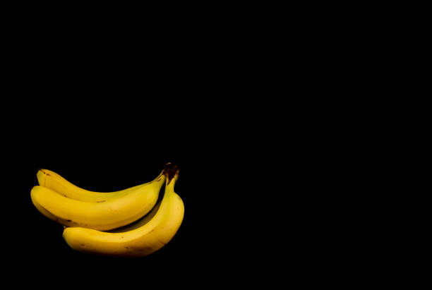 istock Yellow and ripe bananas isolated on black background with copy space 1441633142