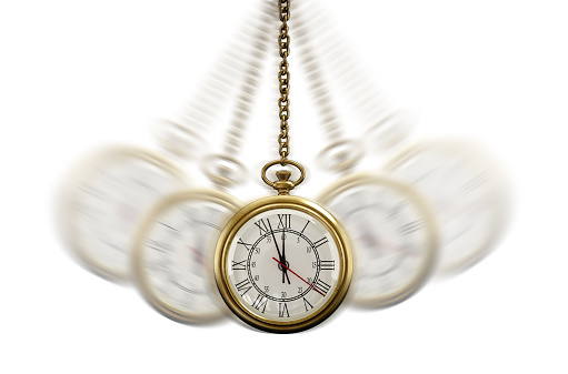 Gold Pocket watch swinging hypnotically from chain. White background. Hypnotism concept.