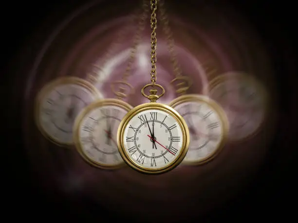 Gold Pocket watch swinging hypnotically from chain. Black background. Hypnotism concept.
