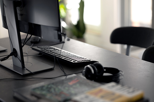 PC computer on work table in modern contemporary office. Corporate business, internet information technology, or freelance job working at home concept