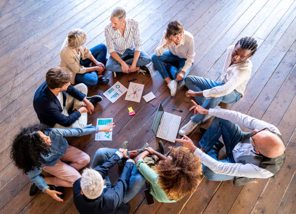 istock Creative business people having a team building session, mixed age range group of designer working together for strategy, teamwork brainstorming 1441640318