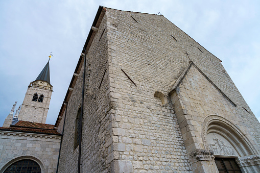 Venzone, Italy - July 7, 2022: Exterior of historic buildings in Venzone, Udine province, Friuli-Venezia Giulia, Italy. Duomo